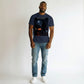 Hustler Design navy blue cotton t-shirt with a graphic print of a hooded figure standing next to a car at night.
