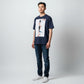 Hustler Design navy blue unisex t-shirt with a graphic print of a man walking on a red path towards a pagoda, text reads "Follow your own path."