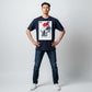 Hustler Design navy blue unisex t-shirt with a minimalist Japanese-inspired graphic featuring a man walking up stone steps towards a traditional building under a red sun.