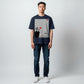 Hustler Design navy blue unisex t-shirt with a minimalist Zen aesthetic print featuring a person meditating on a cliff edge with a bonsai tree and a red sun.